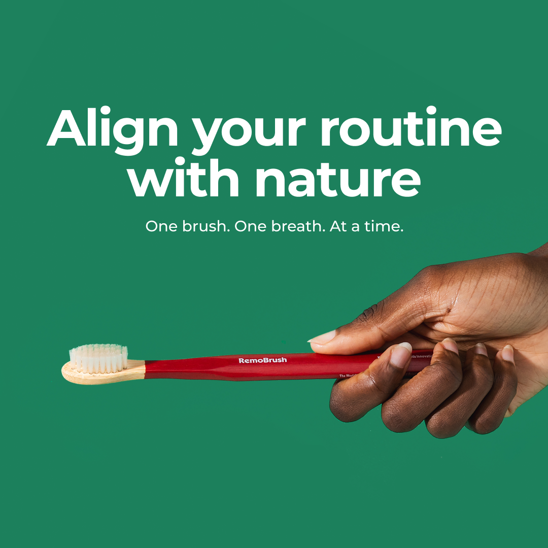 Red toothbrush held by a hand with 'RemoBrush' branding on a green background.